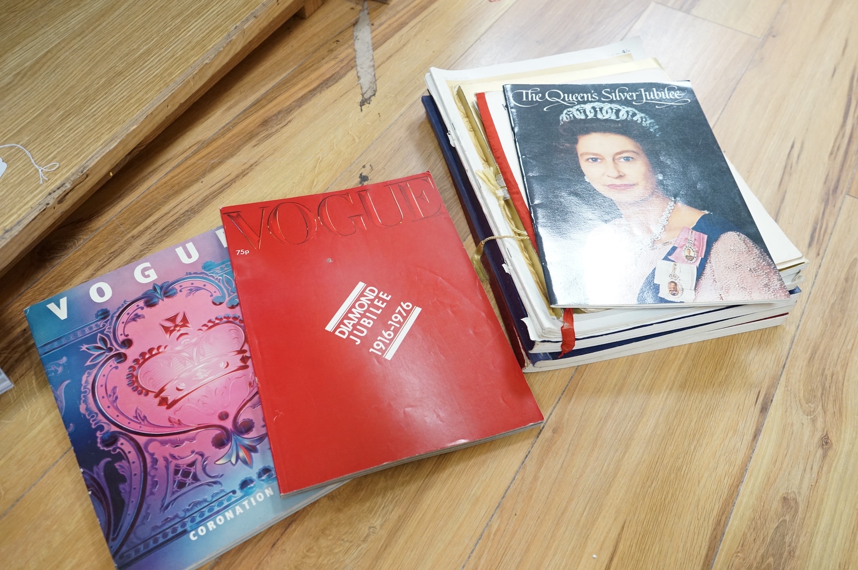 A collection of commemorative books and magazines to include Vogue